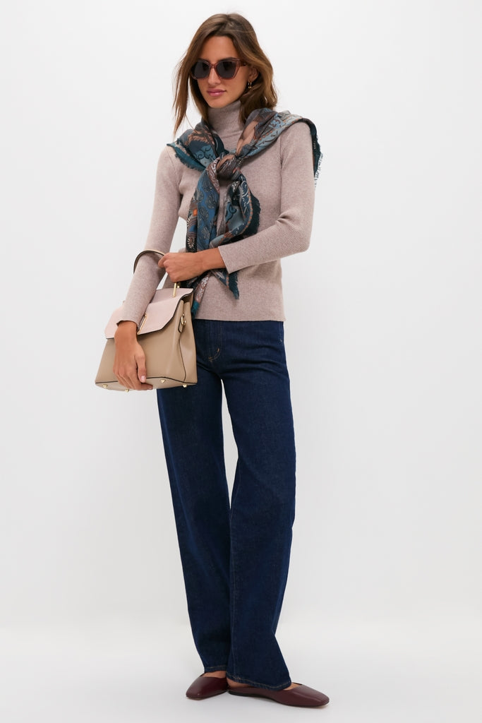 Woman in a turtleneck and jeans wearing the classic Cafe Ole Evie Polarized Sunglasses, showcasing effortless style with a fun, high-end touch.