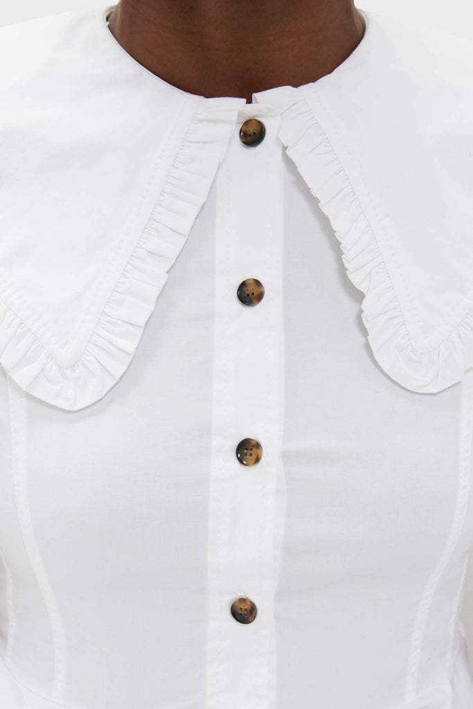 Classic Bright White Stretch Cotton Peter Pan Collar Shirt with a ruffled trim and tortoiseshell-style buttons, offering an effortless, high-end look for fun, confident style.