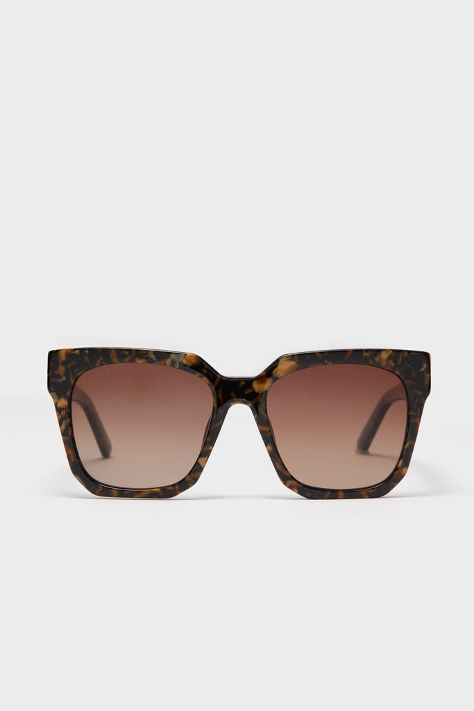 Glitter Tortoise Ariana Polarized Sunglasses feature oversized, square tortoiseshell frames with gradient brown lenses, offering a classic, effortless, and high-end look for fun, everyday wear.
