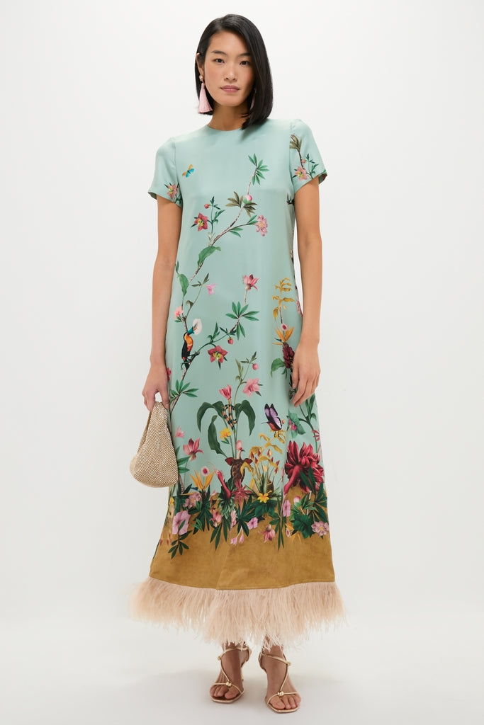 A model showcases the Vintage Rose Francine Earrings, paired with an effortless, high-end tropical print dress and metallic pouch, embodying classic, fun style.