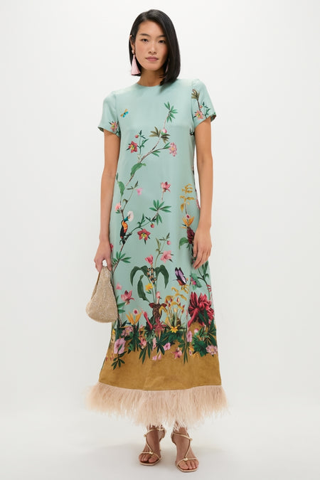 A model showcases the Vintage Rose Francine Earrings, paired with an effortless, high-end tropical print dress and metallic pouch, embodying classic, fun style.