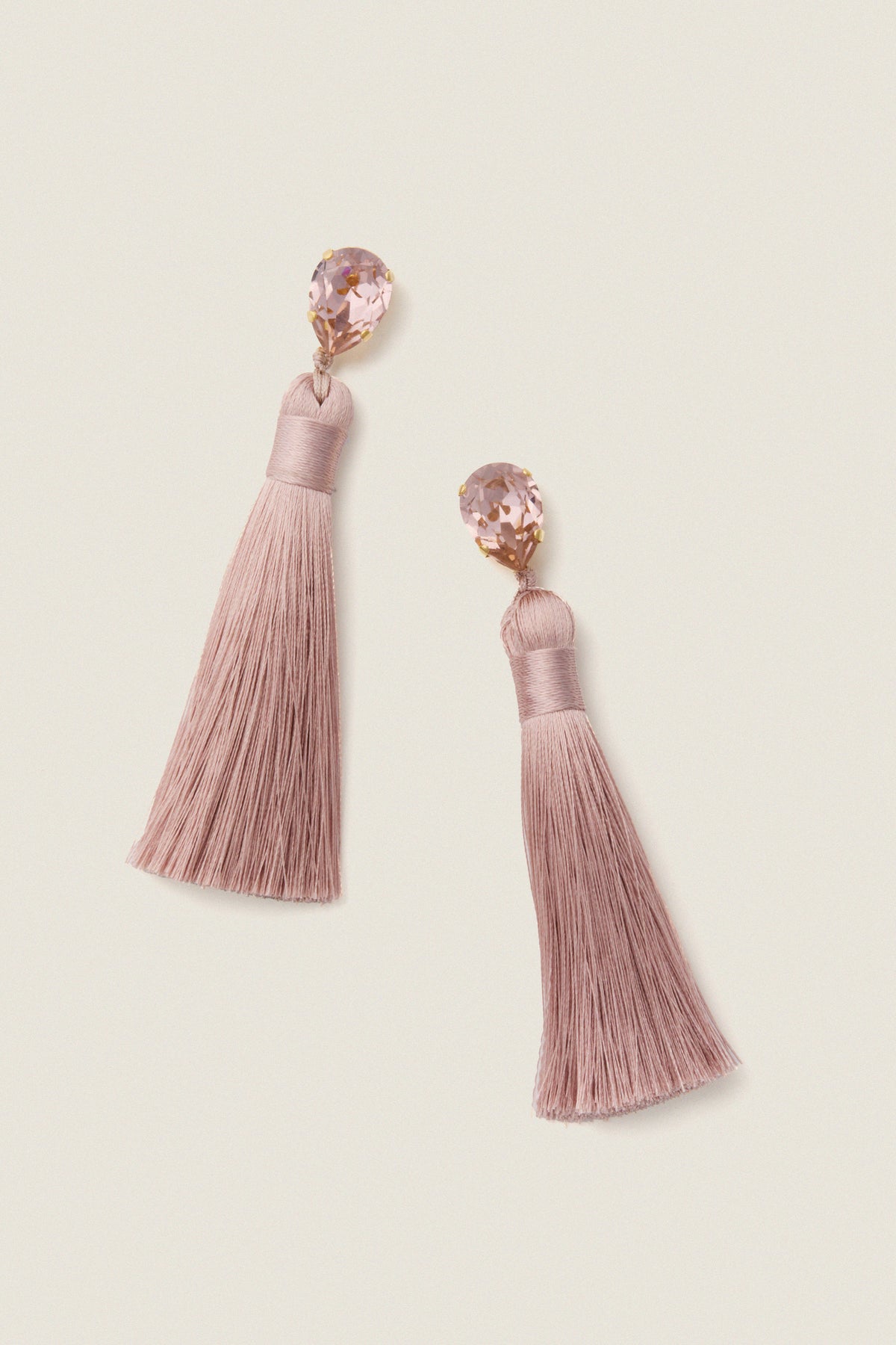 Vintage Rose Francine Earrings with pear-shaped crystals and silky tassels exude classic, effortless glam, perfect for a fun, high-end occasion.
