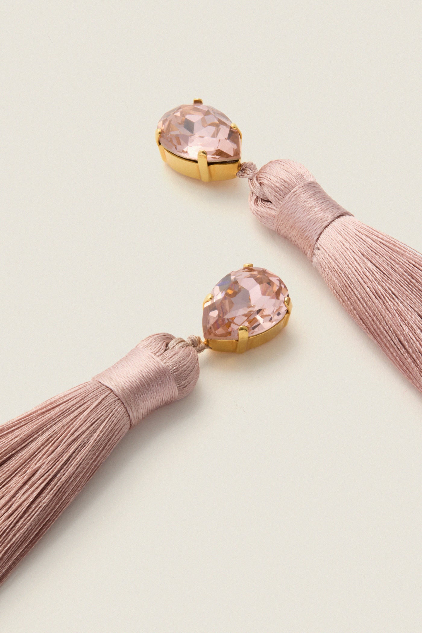 Vintage Rose Francine Earrings showcase classic, effortless style with blush tassels and pear-cut crystals, offering high-end glam and fun movement for any elegant occasion.
