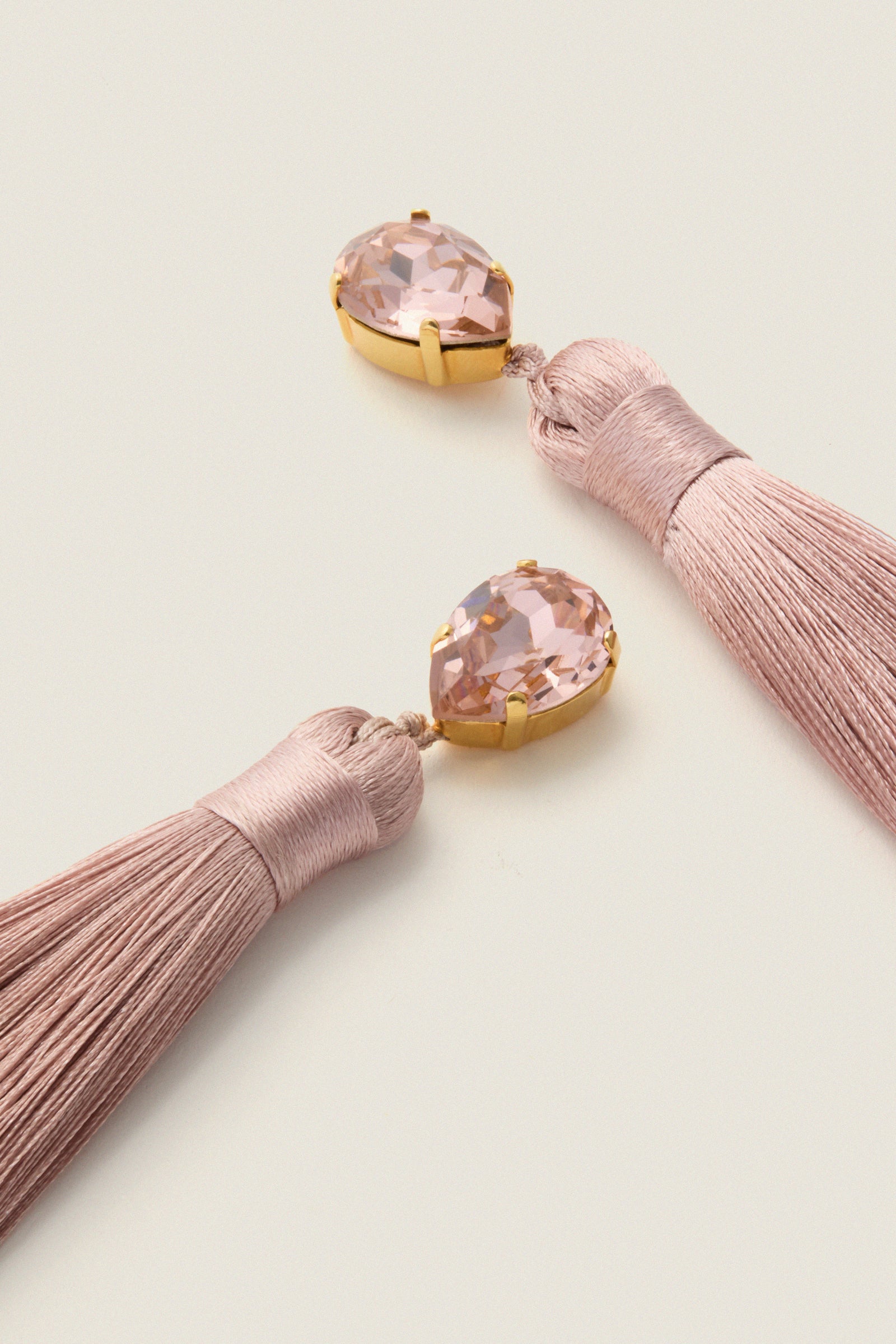 Vintage Rose Francine Earrings showcase classic, effortless style with blush tassels and pear-cut crystals, offering high-end glam and fun movement for any elegant occasion.
