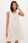 Young woman in an Ivory Lace Organza MaryLiza Swing Dress with elegant lace, pockets, and gold accessories, embodying a classic, effortless, high-end style perfect for any occasion.