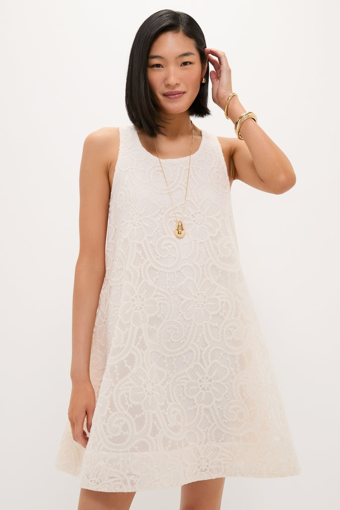 Young woman in an Ivory Lace Organza MaryLiza Swing Dress with elegant lace, pockets, and gold accessories, embodying a classic, effortless, high-end style perfect for any occasion.