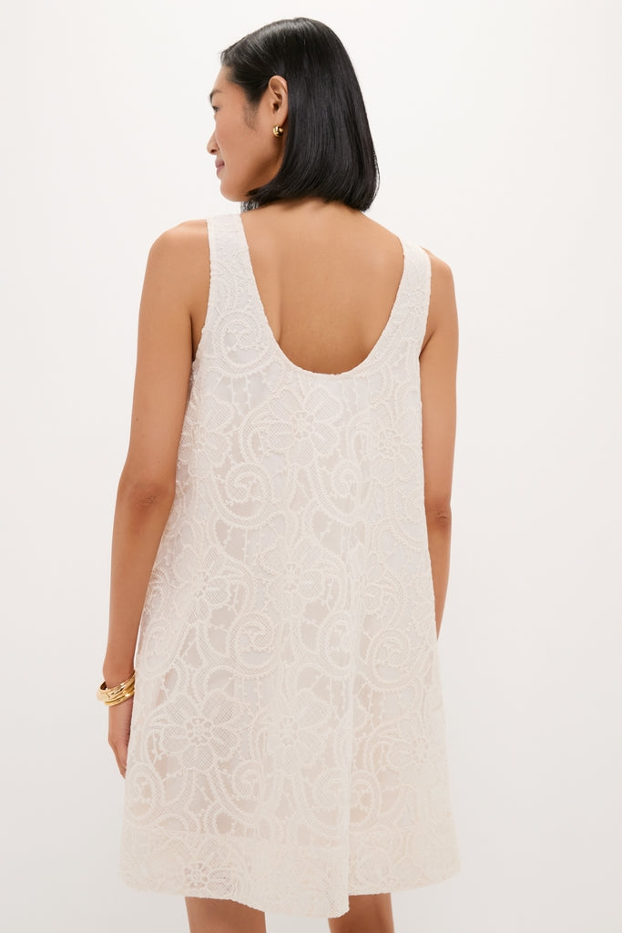 Ivory Lace Organza MaryLiza Swing Dress showcases an effortless, classic design with a scoop back and floral lace pattern, styled with gold earrings for a high-end, fun look.