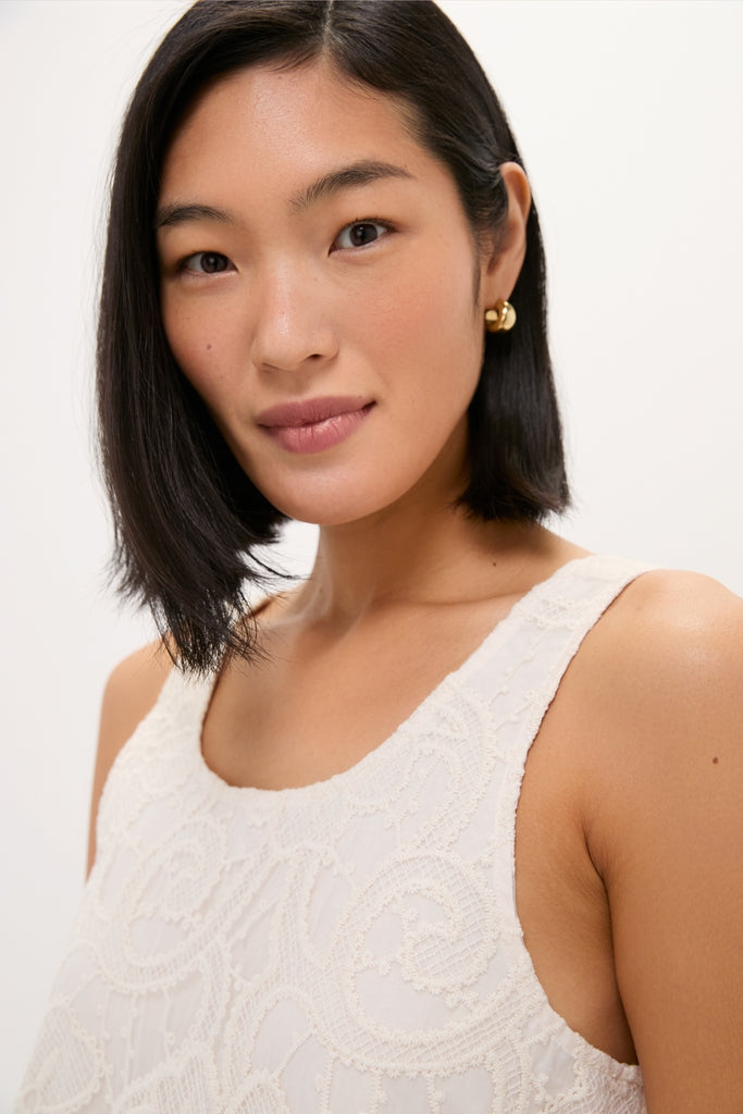 Ivory Lace Organza MaryLiza Swing Dress: A classic, effortless silhouette with a scoop neckline and pockets, paired perfectly with gold hoop earrings for a high-end, fun look.