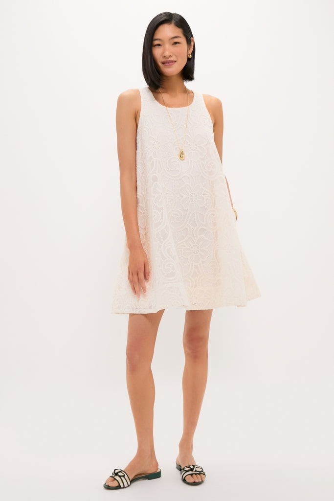 Woman models the Ivory Lace Organza MaryLiza Swing Dress, showcasing its classic A-line silhouette, scoop neckline, elegant lace texture, and functional pockets, epitomizing effortless, high-end style.