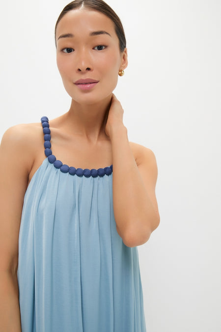Young woman in a classic, effortless Light Blue Chiffon Amelia Bauble Dress with bead-accented strap, embodying Tuckernuck's fun, high-end style.