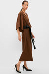 Model in a classic, effortless Chocolate Brown Satin Emiliana Maxi Dress with kimono sleeves and a tassel-tied belt, paired with high-end stiletto pumps.