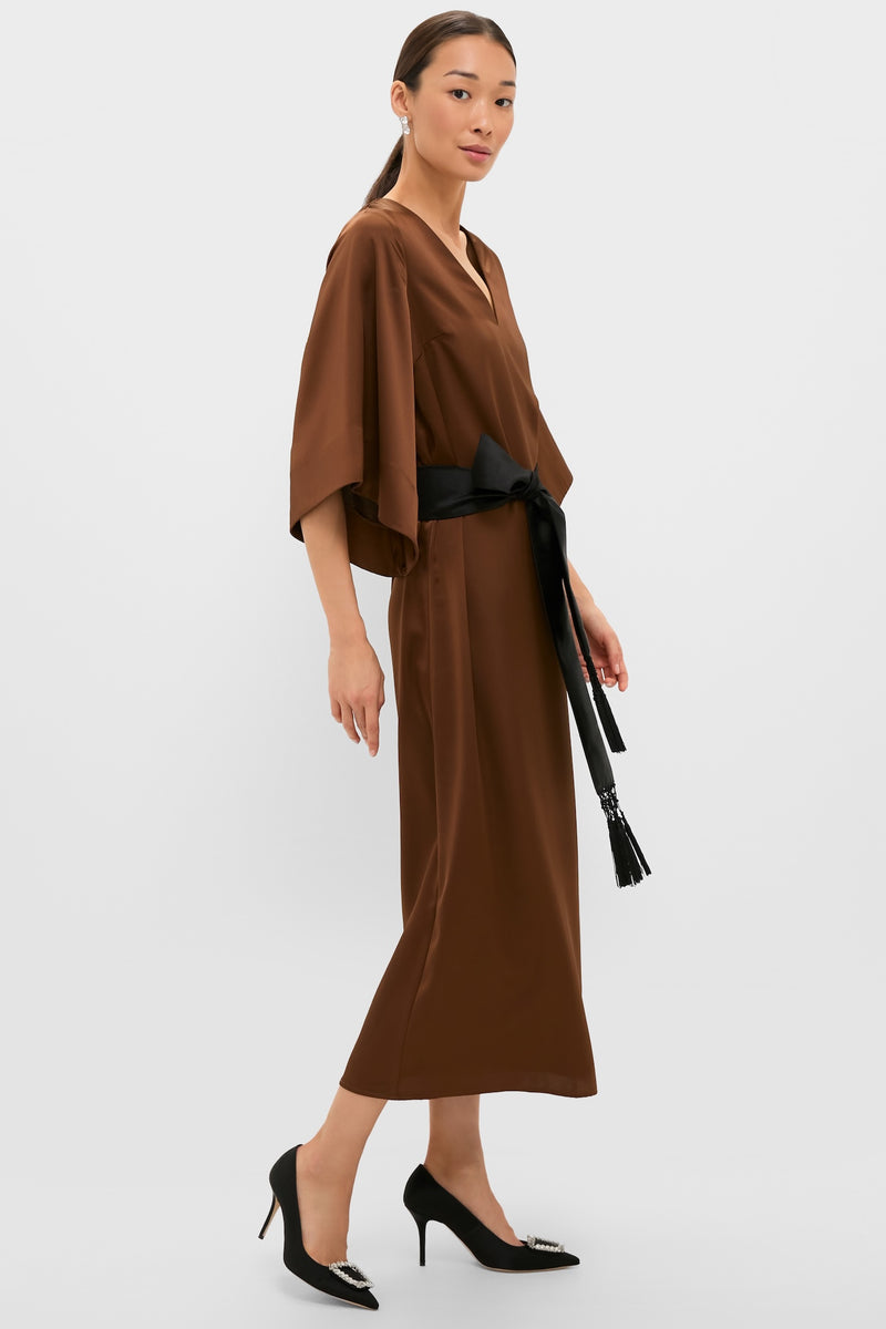 Model in a classic, effortless Chocolate Brown Satin Emiliana Maxi Dress with kimono sleeves and a tassel-tied belt, paired with high-end stiletto pumps.