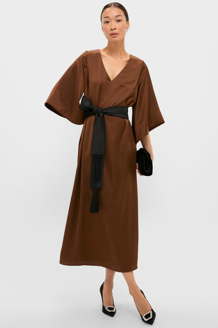 Effortless elegance in the Chocolate Brown Satin Emiliana Maxi Dress, featuring a classic V-neck, kimono sleeves, and a high-end tasseled sash. Perfect with heels and clutch.