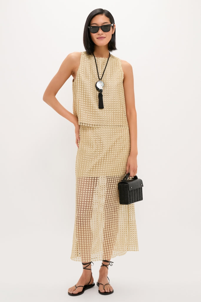 Woman models the classic, effortless Gold Metallic Star Lace Eve Skirt with airy texture, paired with a Keating Top, embodying Tuckernuck's fun, high-end style.