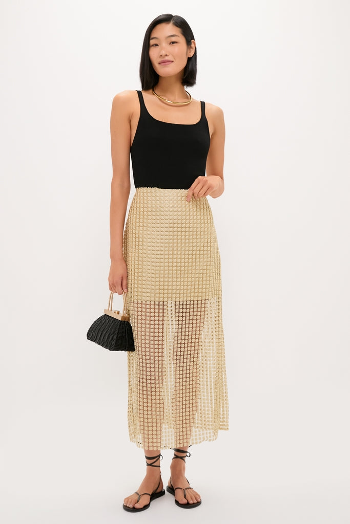 Young woman models the high-end Gold Metallic Star Lace Eve Skirt, exuding effortless glam with its airy texture and classic style, epitomizing Tuckernuck's fun, confident fashion.