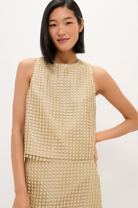 Woman in a classic, sleeveless beige waffle-textured top with matching skirt, embodying effortless high-end style and fun sophistication, reflecting Tuckernuck's chic, coordinated elegance.