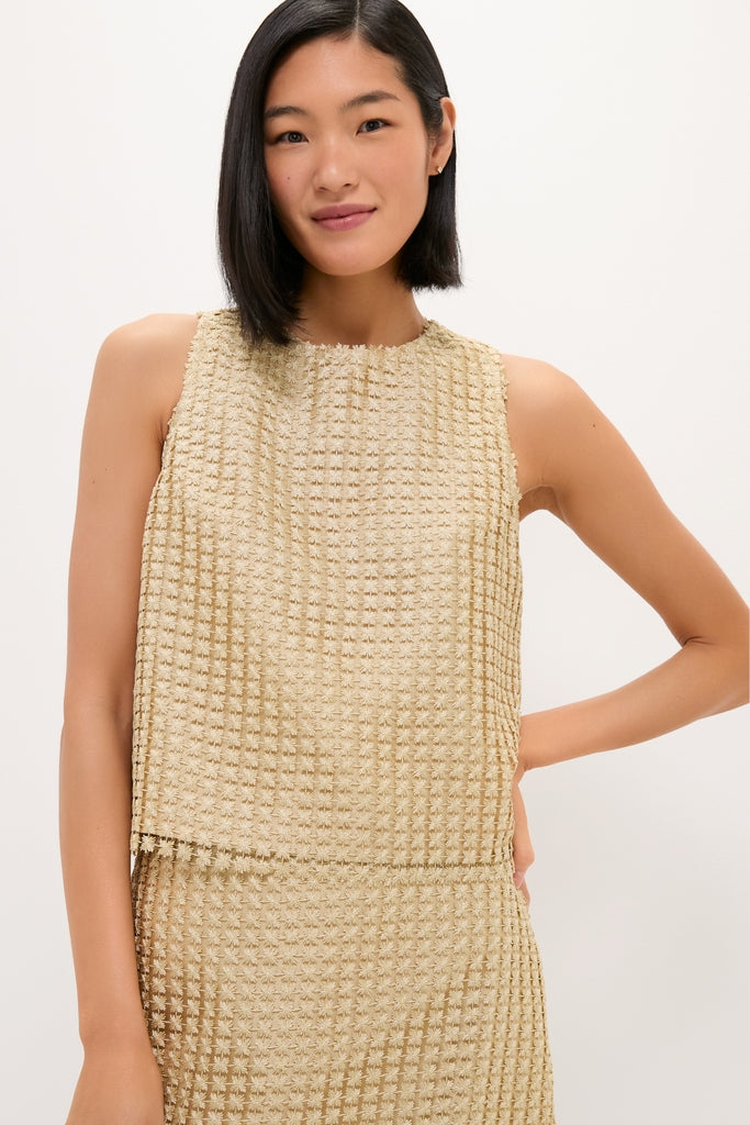 Woman in a classic, sleeveless beige waffle-textured top with matching skirt, embodying effortless high-end style and fun sophistication, reflecting Tuckernuck's chic, coordinated elegance.