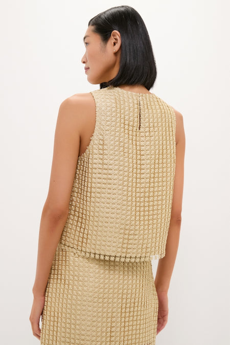 Back view of a person in the classic, high-end Gold Metallic Star Lace Keating Top, showcasing its effortless, fun style with a relaxed fit and button back closure.