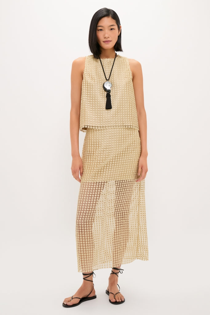 Young woman in a classic, effortless gold Metallic Star Lace Keating Top and Eve Skirt, exuding fun, high-end style with a chic, coordinated look.