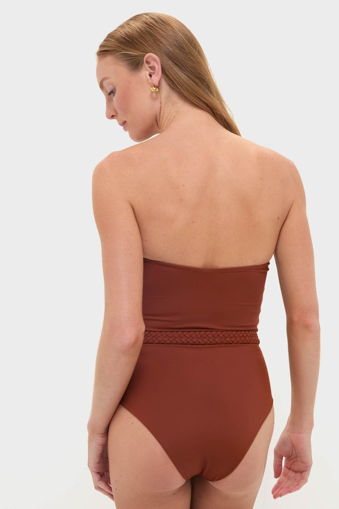Woman wearing Marsala The Classic One Piece swimsuit with a braided belt, embodying an effortless, high-end style. Perfectly paired with gold hoop earrings for a fun, classic look.
