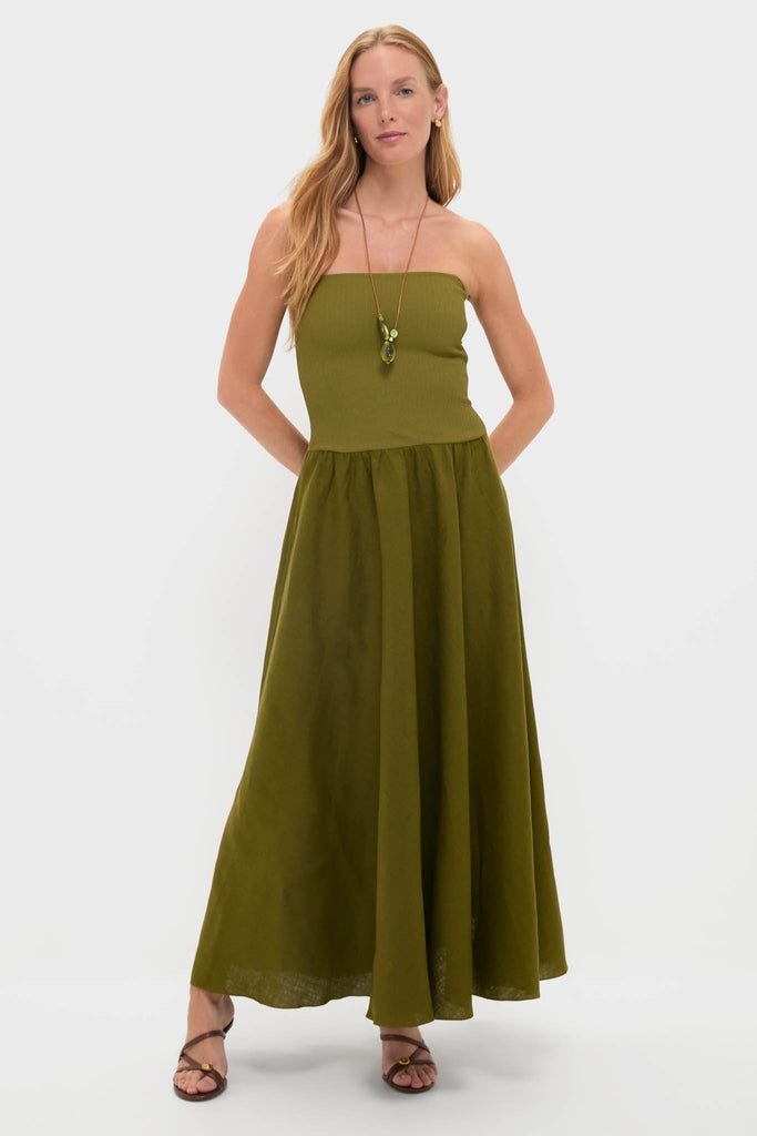 Model wears the classic Green Empowerment Movement Ankle Skirt as a strapless dress, featuring an effortless ribbed bodice and flowing skirt, styled with fun accessories.