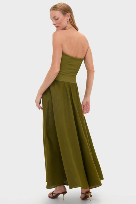 Model in classic, olive-green Green Empowerment Movement Ankle Skirt, worn strapless, paired with brown heeled sandals and gold hoops for an effortless, high-end look.