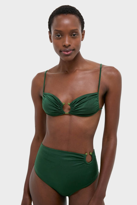Woman models the classic Sumatra Green Tangle Up Bikini Top with an effortless beaded ring and ruched detail, embodying fun, high-end style.