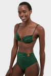 Young Black woman in a classic, high-end Sumatra Green Tangle Up Bikini Top with beaded ring and ruched detailing, exuding effortless style and fun.