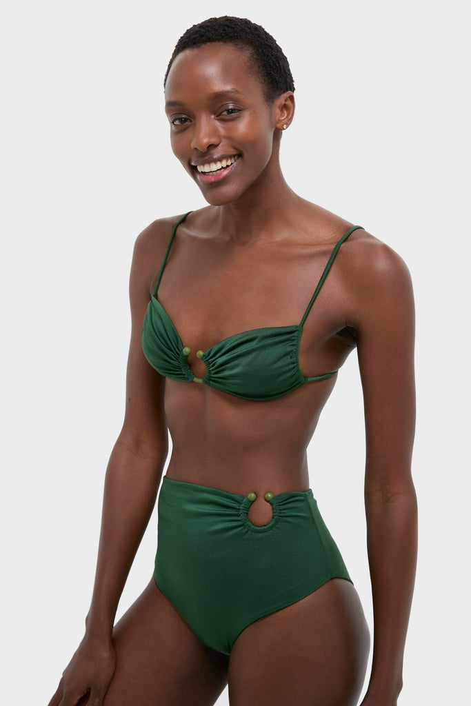 Young Black woman in a classic, high-end Sumatra Green Tangle Up Bikini Top with beaded ring and ruched detailing, exuding effortless style and fun.