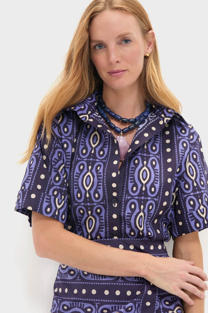Woman in a classic, effortless Navy and Ecru Salty Promises Shirt with bold print, accessorized with chunky beads, embodying fun and high-end fashion.