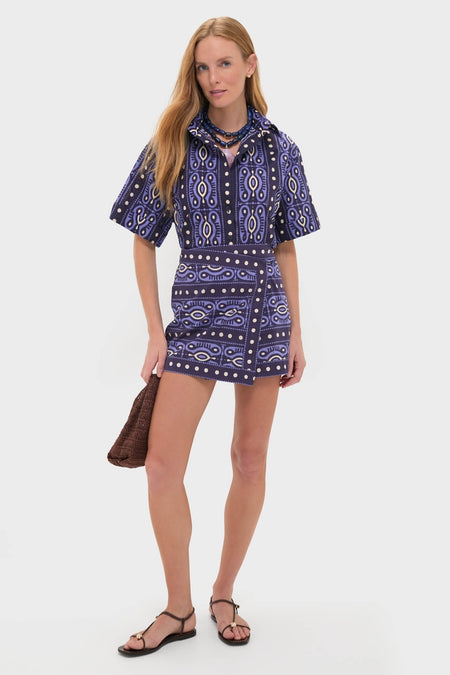 Model wearing the Navy and Ecru Salty Promises Shirt, a classic, high-end, tribal-print button-down, styled effortlessly with a matching skirt and accessories for a fun, getaway look.