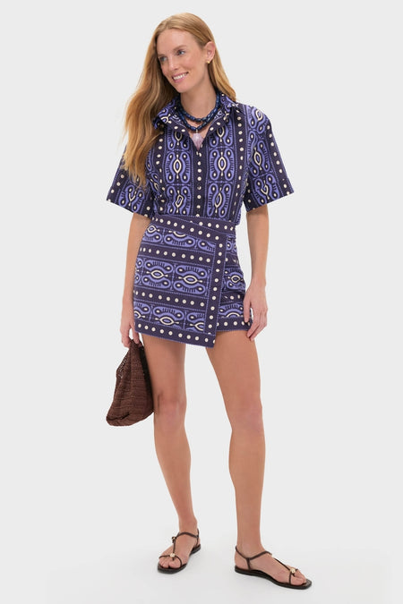 Model in classic Navy and Ecru Hunting Roots Wrap Skirt, showcasing effortless style with playful print, paired with a matching shirt, embodying high-end, fun fashion.
