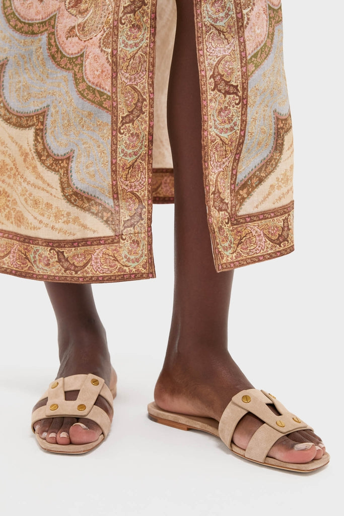 Classic and effortless, the Sand Via Slides feature light beige suede in an H strap design with gold stud accents, perfect for a fun, high-end look.