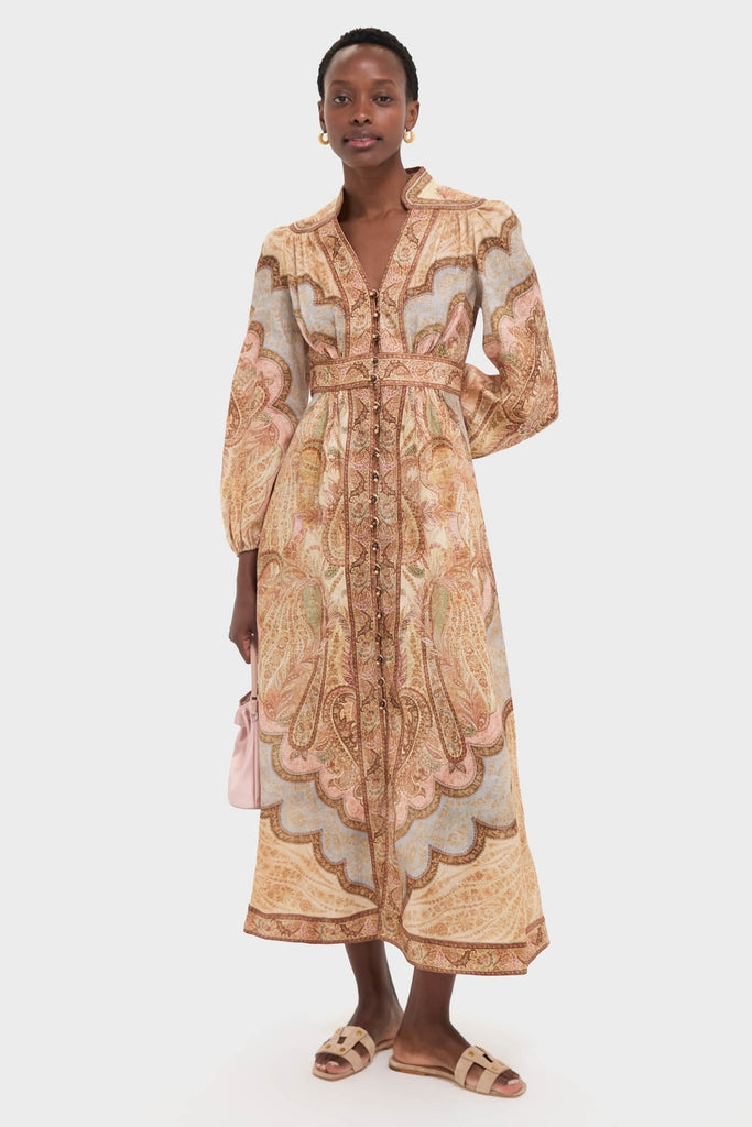 Model showcases a classic, ankle-length paisley dress with a notched collar, paired with Tuckernuck's effortless Sand Via Slides, embodying a fun yet high-end style.