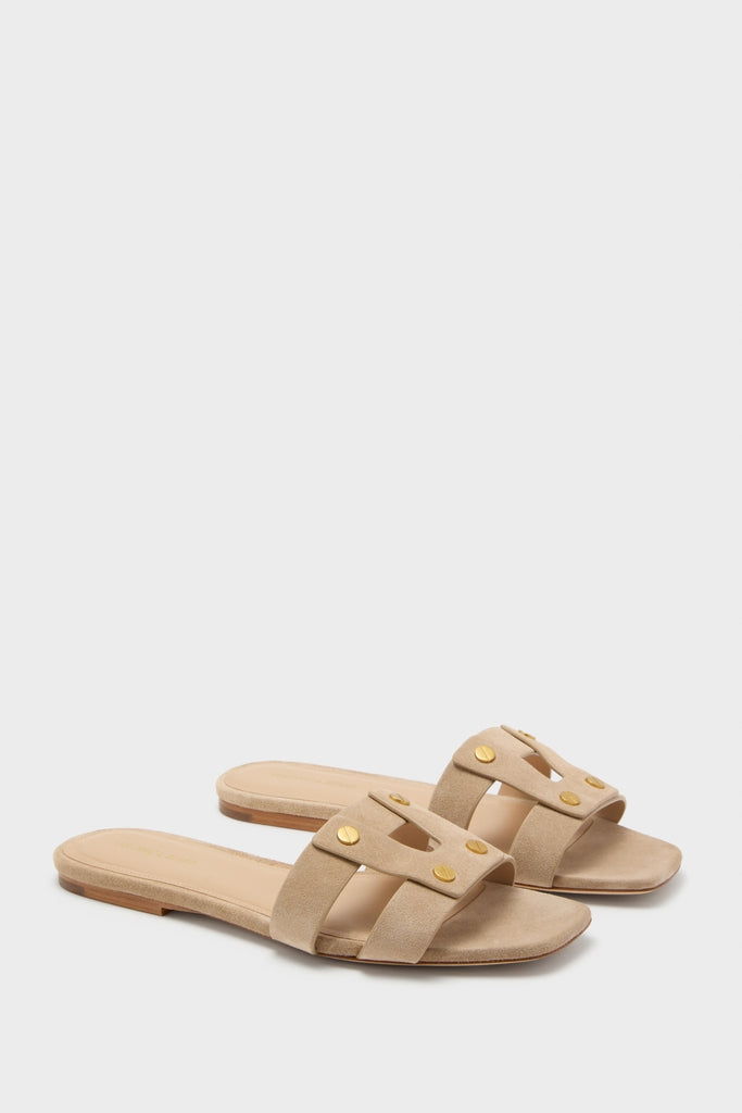 Sand Via Slides: Classic, effortless women’s flat slide sandals with a two-strap design, cut-outs, and gold-tone rivet details, embodying a fun and high-end style.