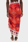 Back view of a person wearing the Red, Ecru, and Dark Cherry Dance of Pareo, a classic, effortless wrap-style skirt with bold palm-tree motifs, exuding fun, high-end style.