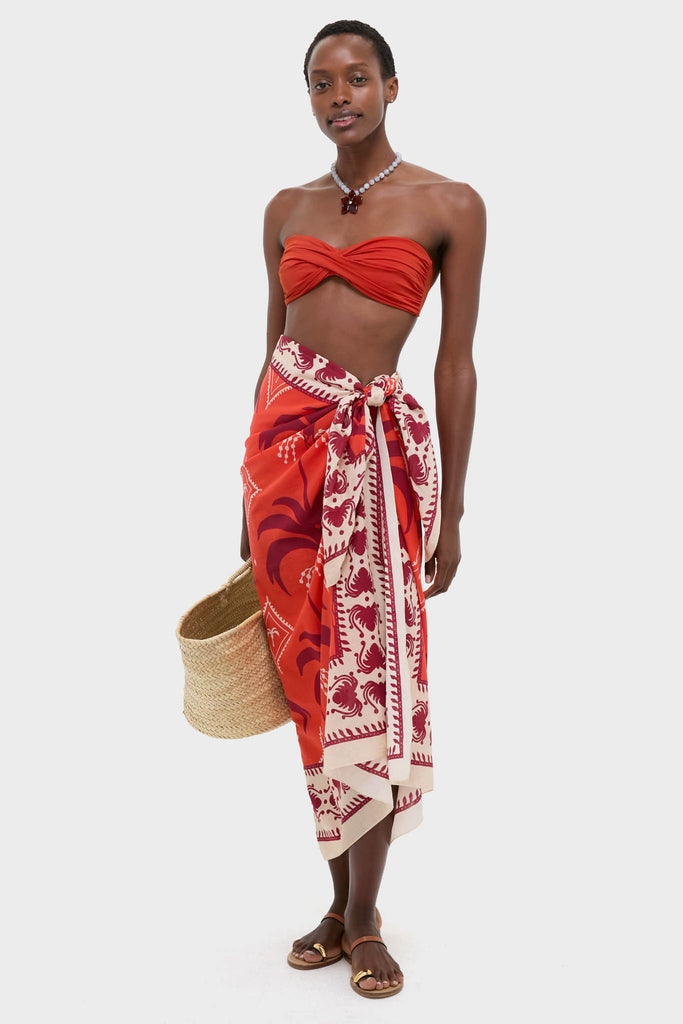 Woman models the classic Red, Ecru, and Dark Cherry Dance of Pareo, styled effortlessly with a vibrant twisted bandeau top and fun, high-end accessories.