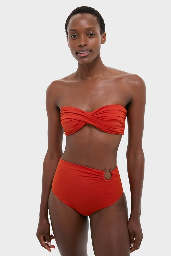 Slender woman models the Fire Red Sea Sprite Bikini Top, a classic, effortless bandeau with a twist-front design, reflecting Tuckernuck's fun, high-end style.