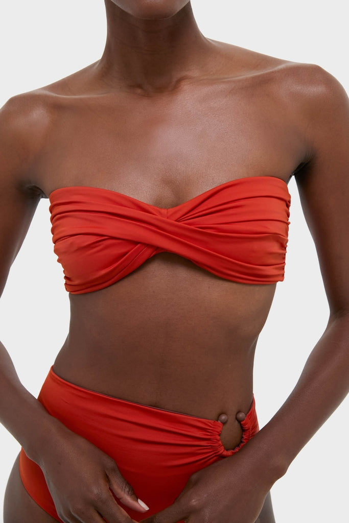 Effortlessly chic Fire Red Sea Sprite Bikini Top with classic bandeau, twist-front design, and high-end details for fun sunbathing style.