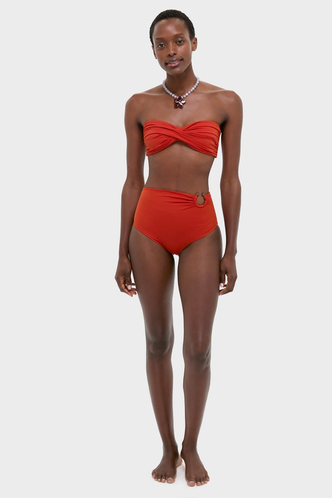 Effortlessly chic Fire Red Sea Sprite Bikini Top with a classic twist-front bandeau style, paired with high-waisted bottoms for a fun, high-end beach look.