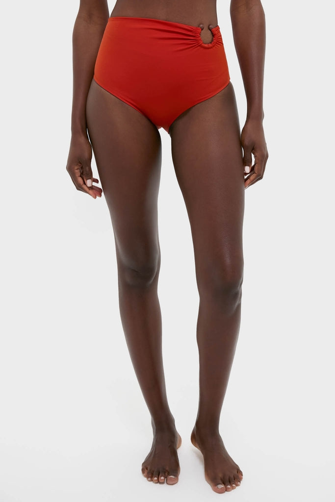 Model wears Fire Red Taita Bikini Bottom with high-rise fit, ruching, and bead detail, embodying a classic, effortless, and high-end style.