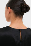 Black Taffeta Keating Top in an elegant bun style, showcasing its classic, effortless design with a back keyhole button closure and high-end glossy finish.