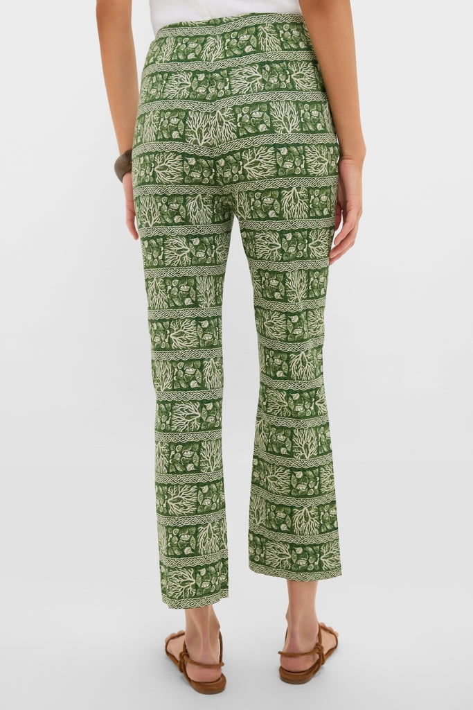 Model showcases the Cowrie Block Print Ashford Pants, featuring a nature-inspired pattern. These classic, ankle-length trousers offer an effortless, high-end style perfect for any occasion.