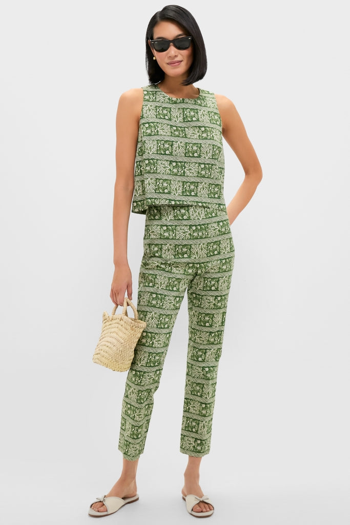 Model wearing Cowrie Block Print Ashford Pants with a sleeveless crop top, styled with white slide sandals, a woven tote, and sunglasses for an effortless, high-end look.