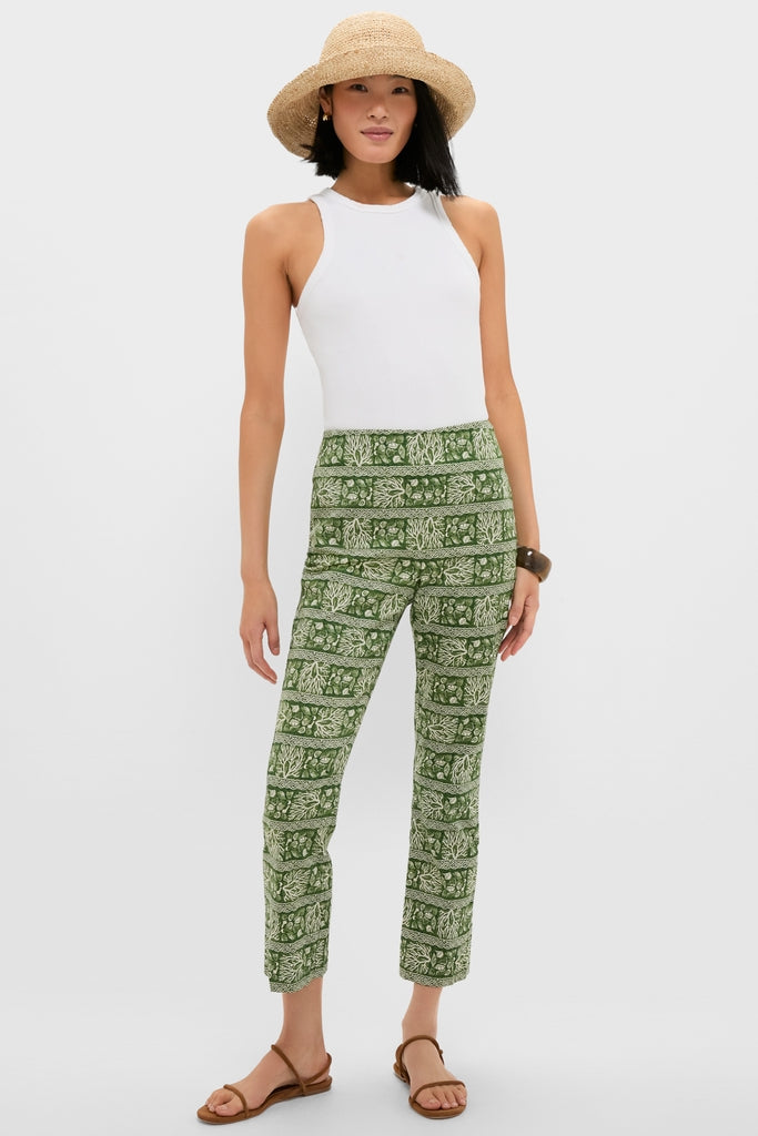 Model wears Cowrie Block Print Ashford Pants, showcasing a classic and effortless style with high-end botanical print, paired with a white tank and straw hat, embodying fun sophistication.