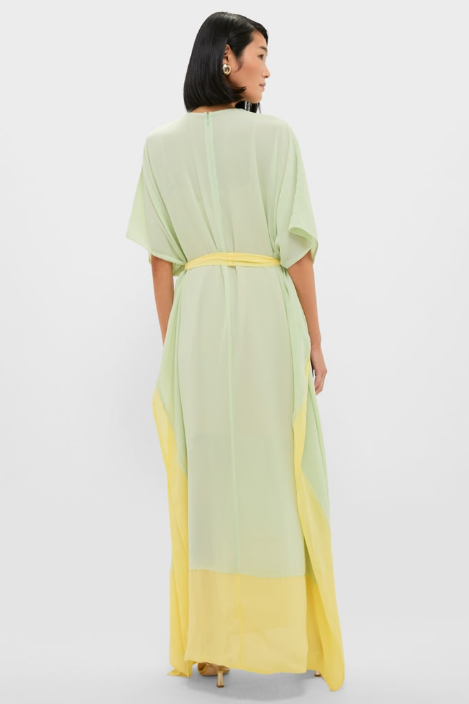 Back view of a woman in a Mint Chiffon Caftan Gown, featuring a classic, effortless flow with a bright citron hem and self-tie belt for a fun, high-end look.