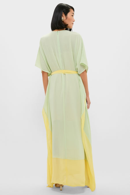 Back view of a woman in a Mint Chiffon Caftan Gown, featuring a classic, effortless flow with a bright citron hem and self-tie belt for a fun, high-end look.