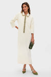 Model wearing the Winter White Embellished Nicola Maxi Dress, featuring jeweled accents, paired with an olive-green clutch and slingback heels, embodying a classic, effortless, high-end look.