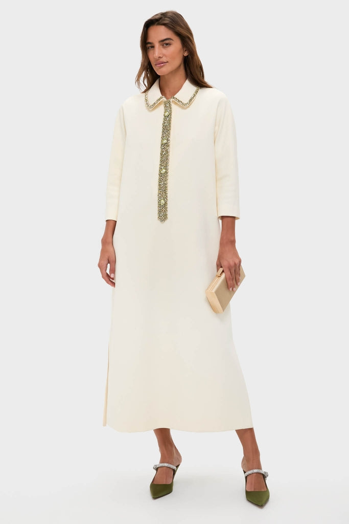 Model wearing the Winter White Embellished Nicola Maxi Dress with jeweled collar and placket, styled with a clutch and green mules for a classic, effortless, high-end look.