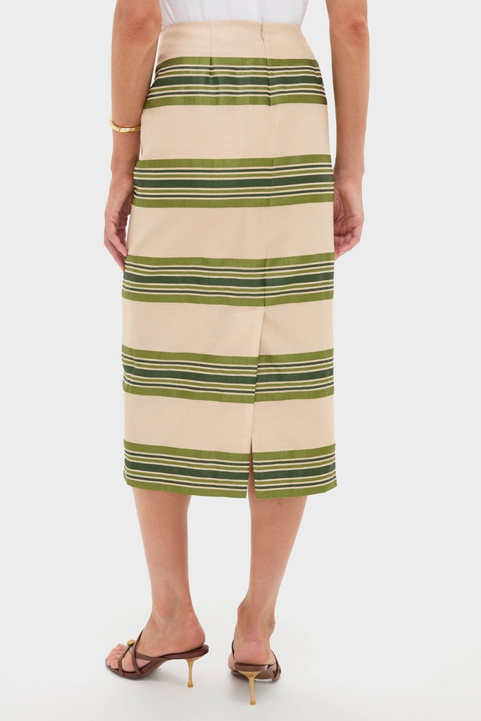 Satin Stripe Ellington Skirt in light beige with olive stripes, classic pencil style, features a back vent. Paired with brown heels and white top, exuding effortless, high-end elegance.